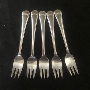 Set of 5 Oxford Hall Arc cocktail oyster forks. Glossy stainless steel.5 3/4”